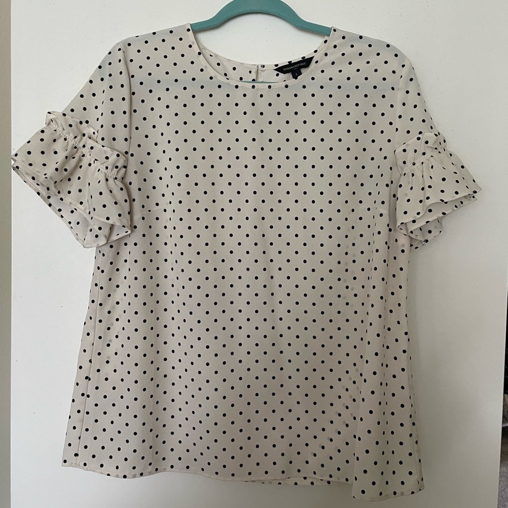 Super cute work blouse with fun ruffle on sleeve!